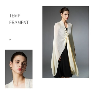 Detail of cream white knitted shawl paired with black dress showing texture and draped layers