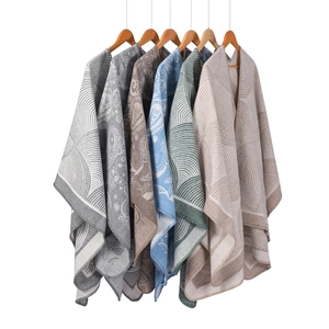Detail of wool blend shawls with diverse paisley patterns and neat edge stitching