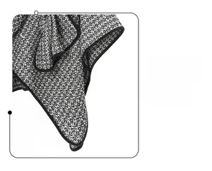 Detailed close-up of the black piping and sewing on a black and white tweed wool shawl