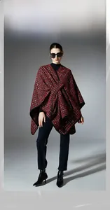 Detail of red tweed Christmas shawl featuring subtle gold tinsel and black trim accents