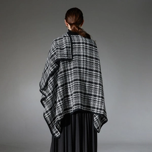 Classic black and white houndstooth tweed shawl with black trim and pleated skirt