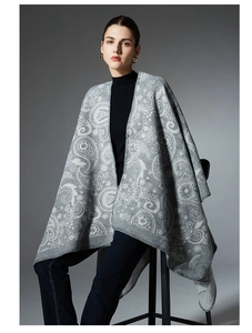 Detailed view of women's knitted paisley wool shawl with grey jacquard pattern