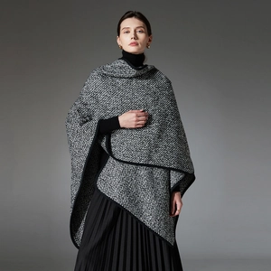 Thick black and white textured knit wool shawl poncho with elegant asymmetric drape design