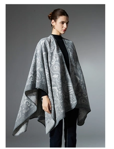 Close-up of grey paisley jacquard pattern and fine stitching on wool blend poncho