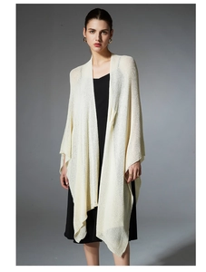 Detail of cream white hollow knit shawl cardigan with elegant lightweight texture