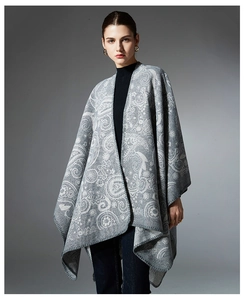 Detail of grey paisley jacquard wool shawl with soft texture and overlock edge finish