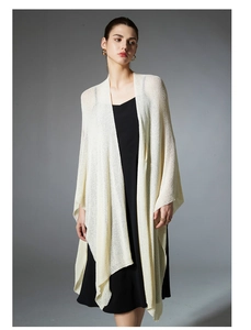 Detail of premium cream white knitted shawl with delicate openwork texture and drape