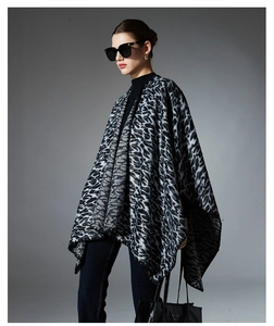 Detail of knitted leopard print shawl showing the soft texture and black draped pattern