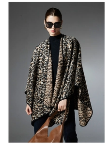 Detail shot of leopard print cross wrap shawl with premium knit texture and fine edging