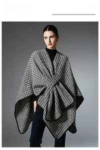 Detail of tweed wool blend knit poncho showing thick black piping and textured weave pattern