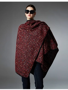 Close-up of red and green sequined tweed shawl with elegant black edge detailing