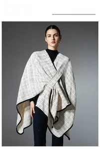 Detail of white plaid shawl with black grid pattern and contrast piping for women