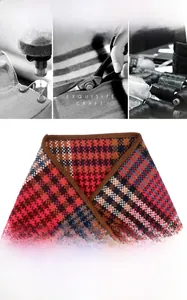 Detail of premium houndstooth scarf showing 100% pure wool texture and leather edge