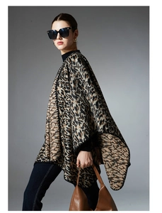 Detailed view of the leopard print knit shawl texture and black stitched edge border