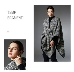 Close-up detail of black and white tweed wool shawl with premium knit texture and piping