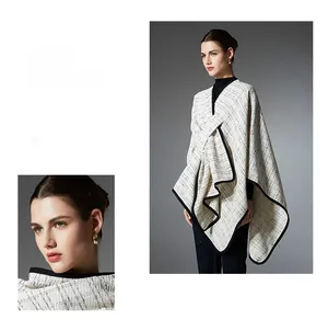 Close-up of black and white plaid shawl with elegant tweed texture and black trim edge
