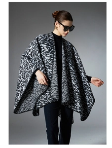 Close-up detail of knitted leopard print shawl wrap for women in black and grey tones