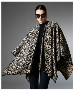 Detail view of the elegant leopard print shawl with irregular hem and knit texture