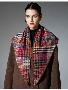 Detailed close-up of premium checkered wool shawl with fine brown piping and rich texture