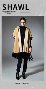 Detail of hooded fringe shawl showing camel and beige double-sided fabric with tassels