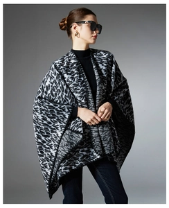 Close-up of black and white leopard print knit shawl with premium soft textured fabric