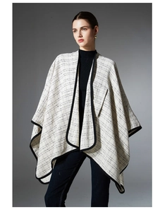 Detail of classic black and white grid tweed shawl cape with contrast piping edge