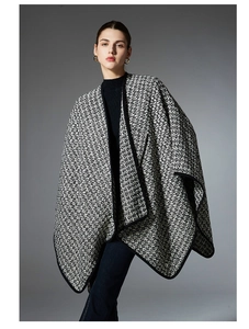 Detail shot of black and white houndstooth wool blend shawl with premium piped edges
