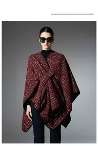 Detail showing the red and black tweed texture and cross-wrap design of the shawl