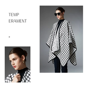 Close-up detail of black and white plaid shawl cape with heavy tweed texture and black trim