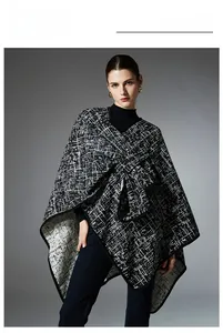 Detail of the high-end black and white plaid faux mink cape with chic asymmetrical cut