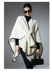 Detail of white waffle knit shawl with black contrast trim and wrap waist structure