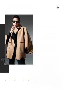 Detail of camel hooded poncho shawl with black wavy stitched edges and Nordic pockets