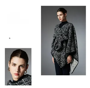 Detail of elegant black and white plaid knit shawl with fringed edges and tweed texture