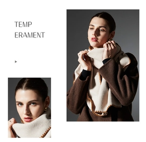 Detailed close-up of cream knit scarf featuring brown zigzag stitching and premium texture