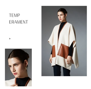 Detail of elegant beige poncho shawl featuring brown leather pockets and piping trim