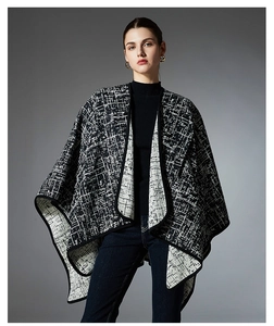 Detailed close-up of a women's black and white checkered knit shawl with premium texture