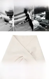 Detail of beige wool knit shawl featuring a secure buckle fastener for anti-slip wear