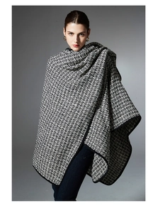 Detail shot of heavy-weight knit wool blend shawl with contrast black edge binding