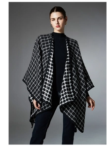Detail view of black and white checkered knit shawl showing the edge binding and fabric texture