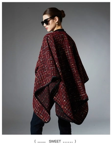 Detailed texture of red tweed shawl with multicolored sequin weaving and black piping