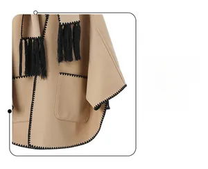 Detail of camel wool shawl featuring black hand-stitched edges and fringe tassels