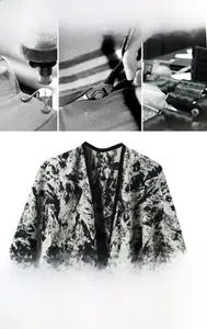 Detail of double-sided jacquard shawl with abstract ink pattern and refined black piping