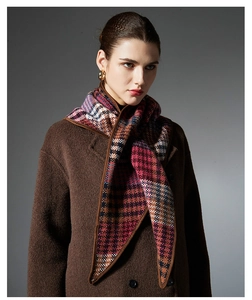 Detail of multi-color wool shawl featuring leather edges and classic plaid pattern