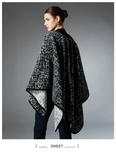 Detailed side view of black and white geometric pattern faux mink fur cape coat