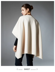 Detail of elegant cream-colored knitted shawl featuring premium leather pocket design