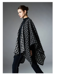 Detail of classic black and white plaid shawl with elegant woven texture and draped fit