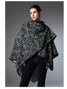 Close-up of black and white geometric knit texture on winter faux mink shawl coat