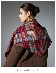 Detail view of multicolored wool blend plaid shawl with premium leather bound edges