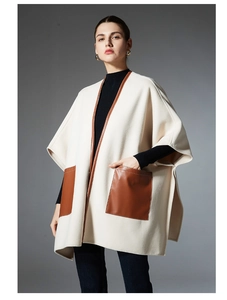 Detail of beige wool-blend shawl with brown faux leather trim and large front pockets