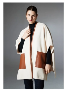 Detail of cream shawl with brown leather pocket contrast and premium wool texture